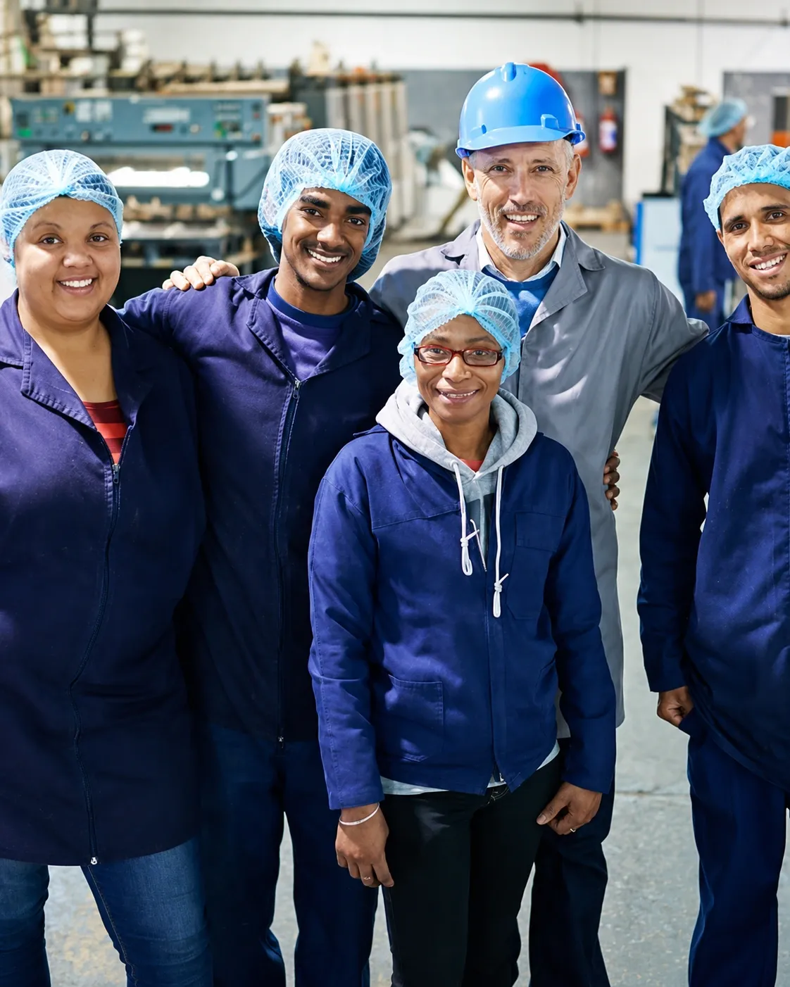 Factory workers in matching navy Cadillac jackets